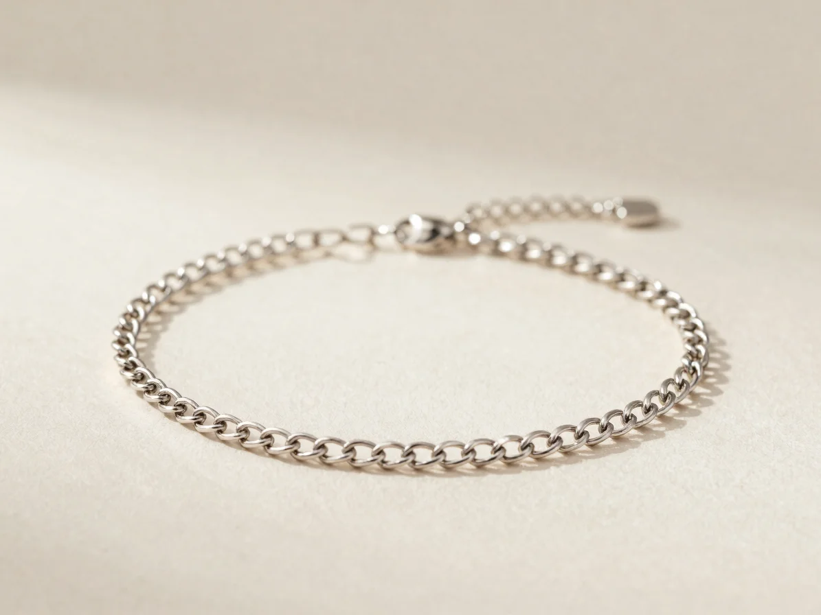 Close studio photograph of a delicate chain bracelet laid across